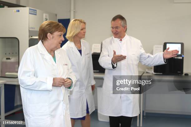 German Federal Chancellor Angela Merkel visits Centogene AG, seen here with the chairman of the board Arndt Rolfs and Mecklenburg-Western Pomerania's...