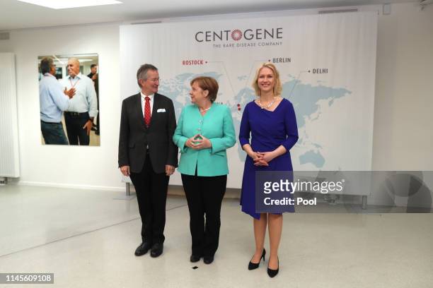 German Federal Chancellor Angela Merkel visits Centogene AG, seen here with the chairman of the board Arndt Rolfs and Mecklenburg-Western Pomerania's...