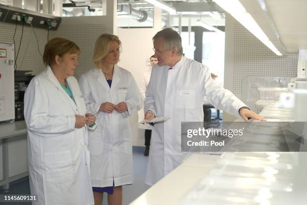 German Federal Chancellor Angela Merkel visits Centogene AG, seen here with the chairman of the board Arndt Rolfs and Mecklenburg-Western Pomerania's...