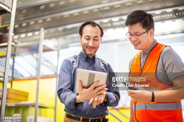 warehouse manager discussing with foreman - factory ipad stock pictures, royalty-free photos & images
