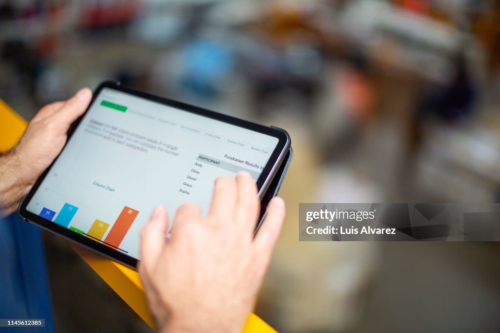 Worker reviewing statistical graphs on tablet pc