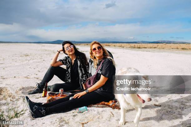 female friends relaxing by the salton sea in california - coachella outfit stock pictures, royalty-free photos & images