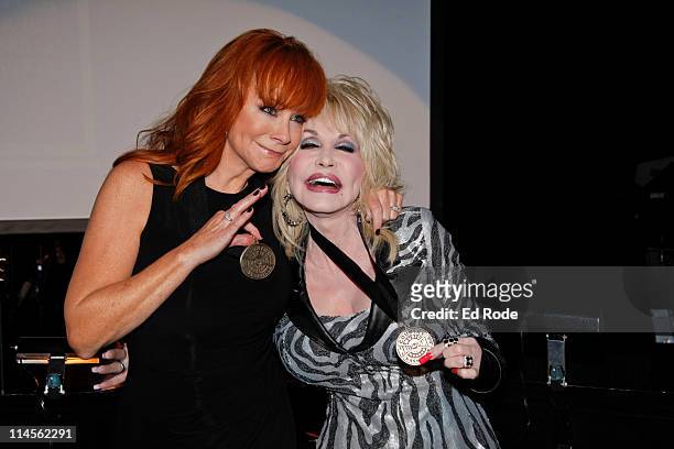 Reba McEntire and Dolly Parton attends the 2011 Country Music Hall of Fame Medallion Ceremony induction at Country Music Hall of Fame and Museum on...