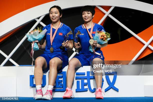 Jia Yifan and Chen Qingchen of China pose after winning the Women's Doubles final match against Mayu Matsumoto and Wakana Nagahara of Japan on day...