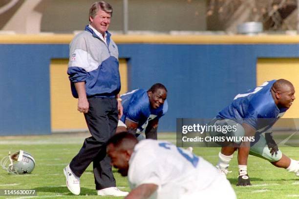 Dallas Cowboys head coach Jimmy Johnson walks the field as his team stretches for workouts 28 January 1993 in preparation for Super Bowl XXVII. The...