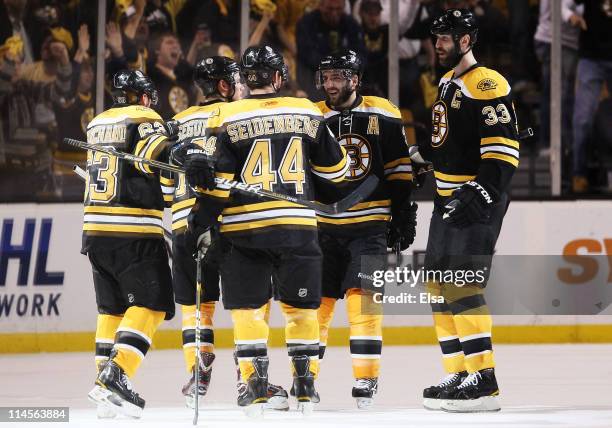 Brad Marchand of the Boston Bruins celebrates his second period goal against the Tampa Bay Lightning with teammates in Game Five of the Eastern...