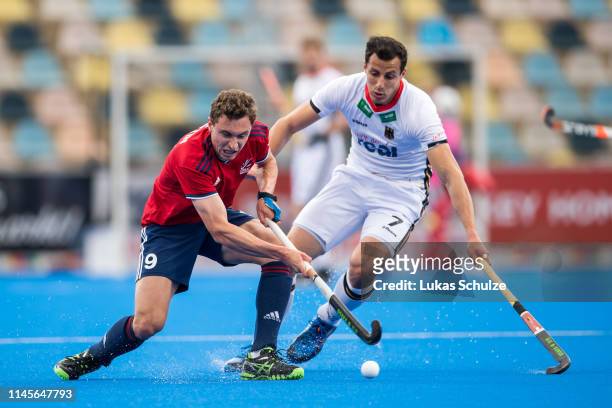 Harry Martin of Great Britain challenges for the ball with Timur Oruz of Germany during the Men's FIH Field Hockey Pro League match between Germany...