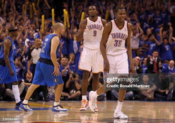 Kevin Durant and Serge Ibaka of the Oklahoma City Thunder react in the fourth quarter while taking on the Dallas Mavericks in Game Four of the...