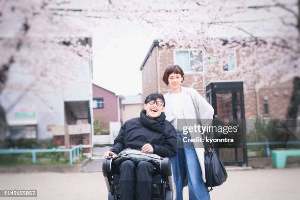 japanese wife and husband on the wheelchair - motorized wheelchair stock pictures, royalty-free photos & images