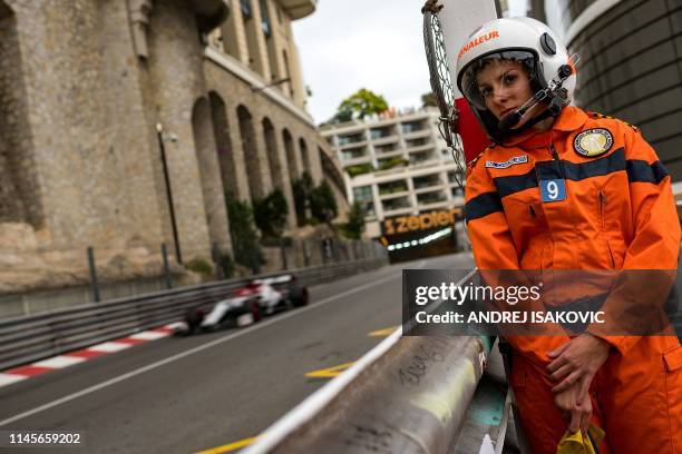 Female track marshal watches during the first practice session at the Monaco street circuit on May 23, 2019 in Monaco, ahead of the Monaco Formula 1...