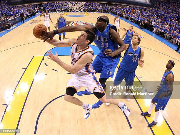 Nick Collison of the Oklahoma City Thunder looks to shoot against Brendan Haywood of the Dallas Mavericks in the second half in Game Four of the...