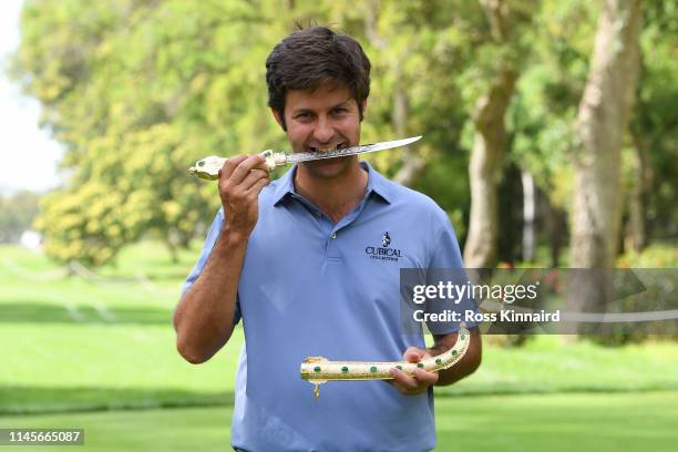 Jorge Campillo of Spain poses for a photo with the trophy after winning the Trophee Hassan II during Day Four of the Trophee Hassan II at Royal Golf...