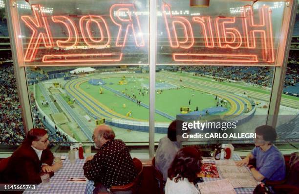 Spectators have lunch at the Hard Rock Cafe inside Toronto's Skydome 12 Mar overlooking the World Indoor Track and Field Championships. The...