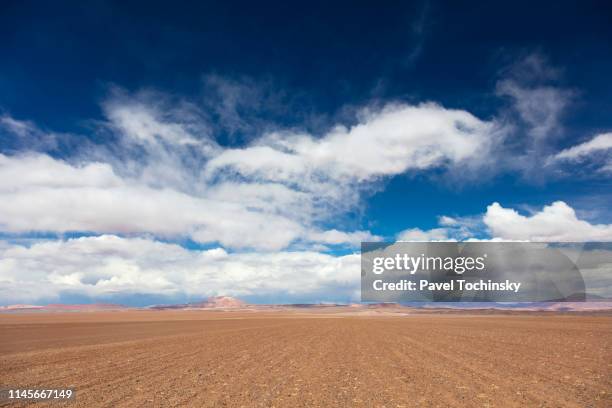 dirt track leading to the salar de tara salt flat, located 4,300m altitude in los flamencos national reserve at the atacama desert, chile, january 18, 2018 - terrain stock pictures, royalty-free photos & images