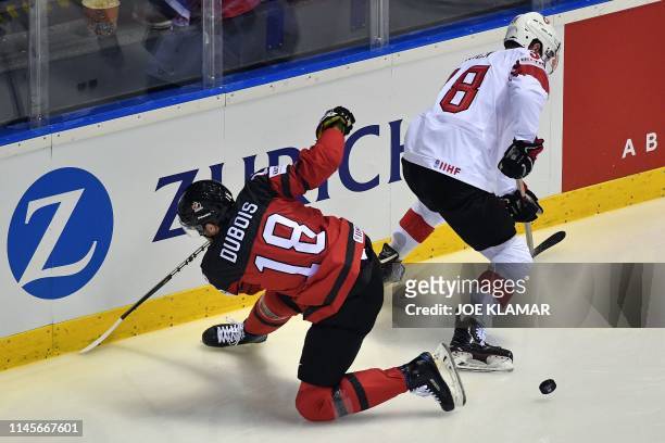 Canada's forward Pierre-Luc Dubois and Switzerland's defender Lukas Frick vie during the IIHF Men's Ice Hockey World Championships quarter-final...
