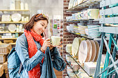 Asian girl shopping for kitchenware in retail store