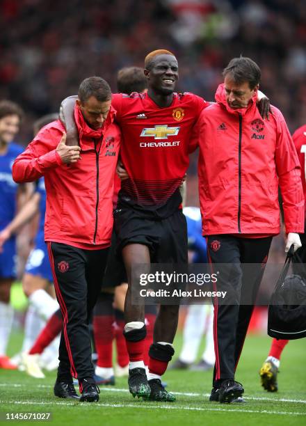 An injured Eric Bailly of Manchester United is given assistance during the Premier League match between Manchester United and Chelsea FC at Old...