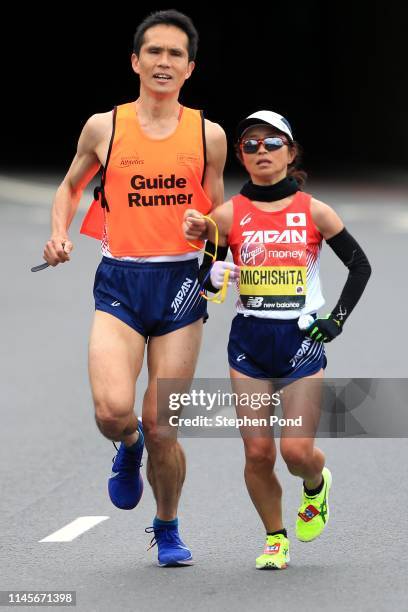 Misato Michishita of Japan and guide in the Women's Para race during the Virgin Money London Marathon on April 28, 2019 in London, England.