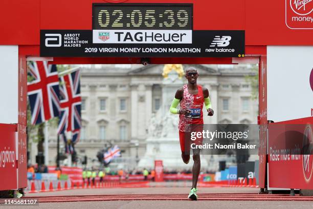 Mo Farah of Great Britain crosses the finish line in 2:05:39 during the Men's Elite race during the Virgin Money London Marathon at United Kingdom on...