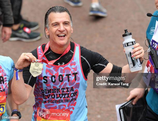 Scott Mitchell poses with his medal after completing the Virgin London Marathon 2019 on April 28, 2019 in London, United Kingdom.