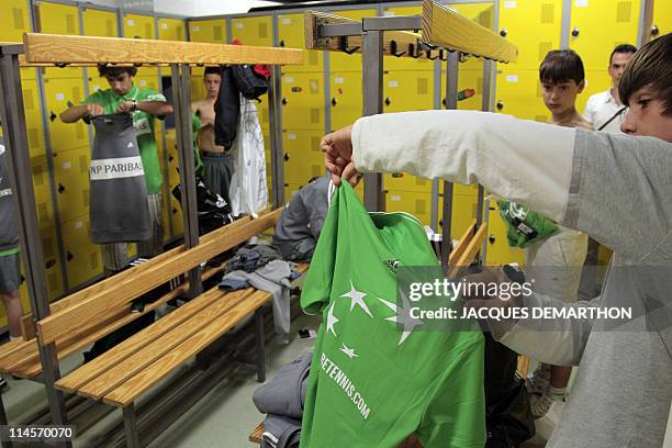 Ball boys try the official shirts in a changing room on May 14, 2011 at Roland-Garros stadium in Paris, they will wear during the French Tennis Open...