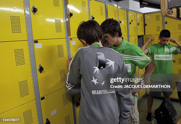 Ball boys try the official shirts in a changing room on May 14, 2011 at Roland-Garros stadium in Paris, they will wear during the French Tennis Open...