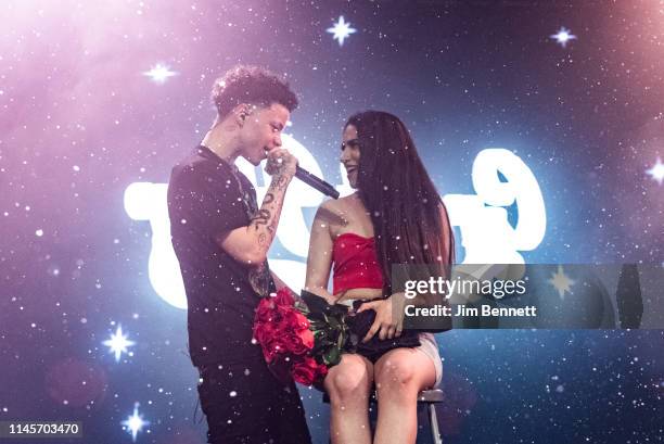 Rapper Lil Mosey performs live on stage with an audience member during the Northsbest Festival at the Showbox SoDo on April 27, 2019 in Seattle,...