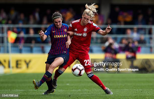 Mariona Caldentey of FC Barcelona competes for the ball with Verena Schweers of FC Bayern Munich during the UEFA Women's Champions League semi final...