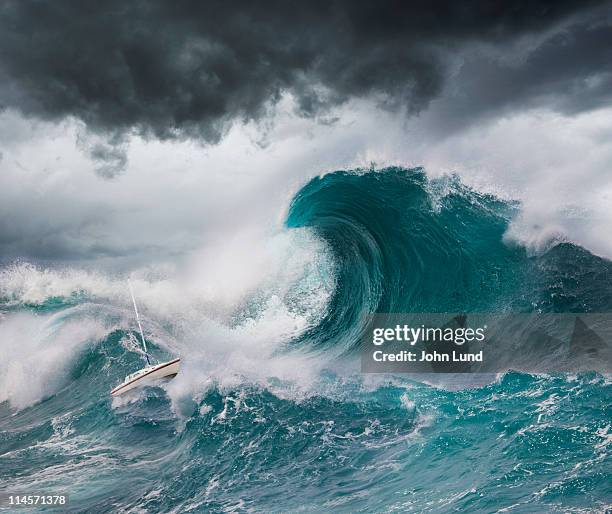 small boat faces a tsunami - tsunami fotografías e imágenes de stock