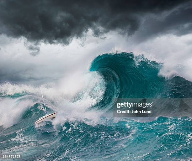 small boat faces a tsunami - tsunami wave stock pictures, royalty-free photos & images