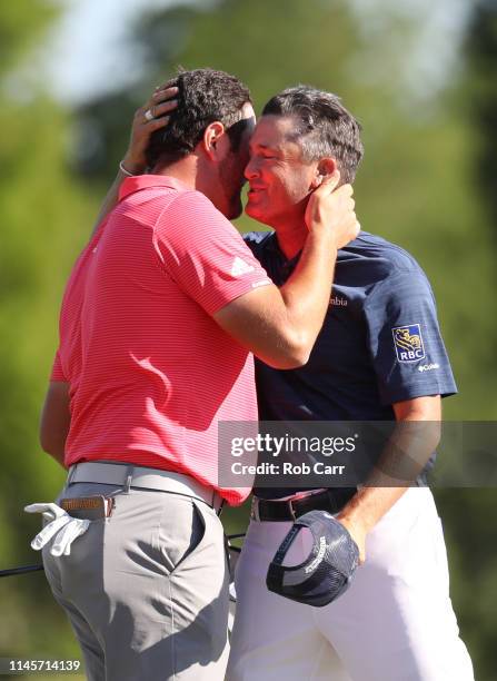 Jon Rahm of Spain and Ryan Palmer of the United States react after putting in to win on the 18th green during the final round of the Zurich Classic...