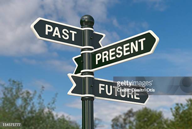 directional signs saying past, present and future - wegwijzer stockfoto's en -beelden