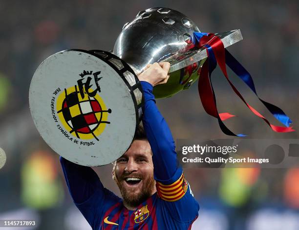 Lionel Messi of FC Barcelona celebrates with the La Liga trophy following his team's victory in the La Liga match between FC Barcelona and Levante UD...