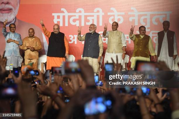 India Prime Minister Narendra Modi flashes the victory sign next to Bharatiya Janta Party president Amit Shah and Minister of Home Affairs of India...