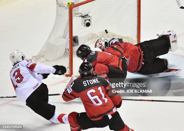 Switzerland's forward Nico Hischier scores during the IIHF Men's Ice Hockey World Championships quarter-final match between Canada and Switzerland on...