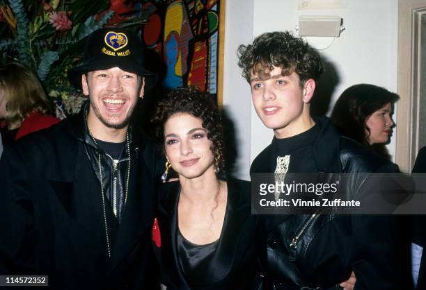 Donnie Wahlberg and Joey McIntyre of New Kids On The Block with singer Gloria Estefan at Spago's, Los Angeles, California, circa 1990.