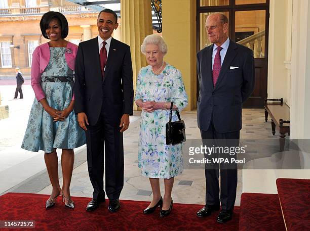 First Lady Michelle Obama, US President Barack Obama, Queen Elizabeth II and Prince Philip, Duke of Edinburgh pose for a photo as they arrive to...