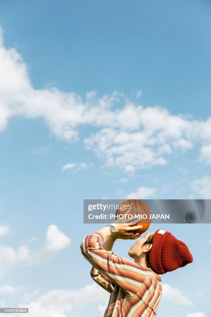 Young man is playing basketball.