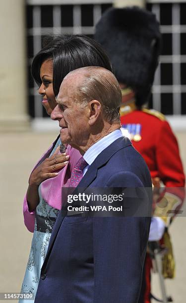 First Lady Michelle Obama and Prince Philip, Duke of Edinburgh stand to listen to the US National Anthem during a ceremonial welcome in the garden of...