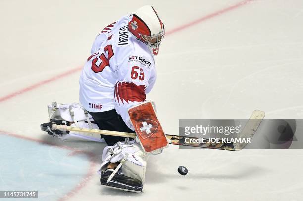 Switzerland's goalkeeper Leonardo Genoni saves the puck during the IIHF Men's Ice Hockey World Championships quarter-final match between Canada and...