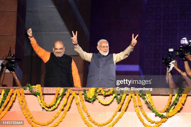 Narendra Modi, India's prime minister, right, and Amit Shah, president of the Bhartiya Janata Party , celebrate during an event at the party's...