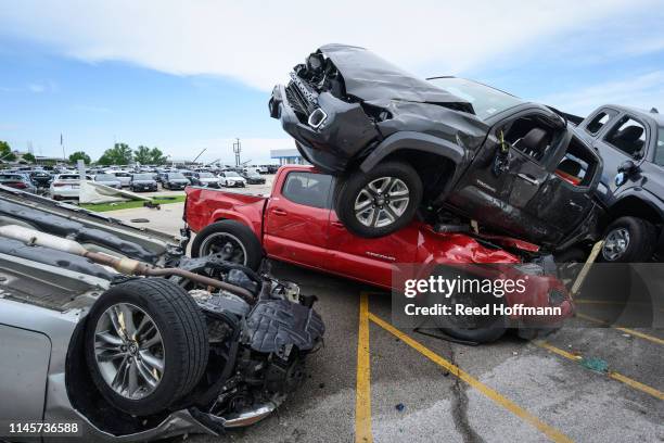 Trucks are piled on top of each other at Riley Auto Group on May 23, 2019 in Jefferson City, Missouri, after a tornado struck there. A series of...