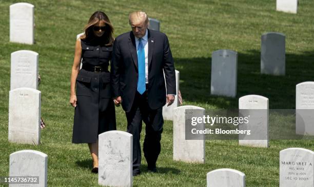 President Donald Trump, right, and First Lady Melania Trump visit Arlington National Cemetery ahead of Memorial Day during the annual Flags In...