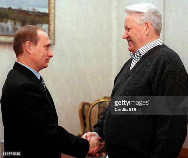 Russian President Boris Yeltsin shakes hands with Prime Minister Vladimir Putin during their meeting at the presidential residence Gorky-9 outside...