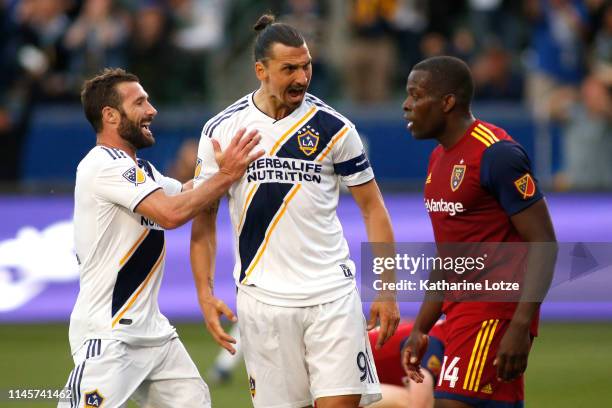 Chris Pontius and Zlatan Ibrahimovic of Los Angeles Galaxy celebrate Ibrahimovic's goal as he yells at Nedum Onuoha of Real Salt Lake during the...