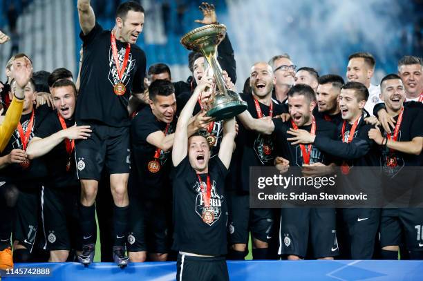 Players of Partizan celebrate with the trophy after winning the Serbian Cup Final match between FK Crvena Zvezda and FK Partizan at stadium Rajko...