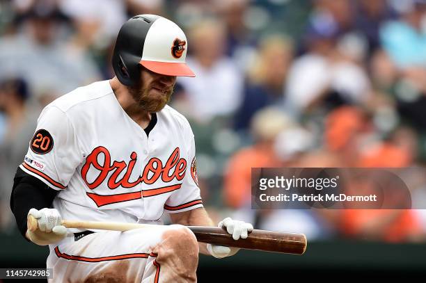 Chris Davis of the Baltimore Orioles tries to break his bat after striking out to end the eighth inning against the New York Yankees at Oriole Park...