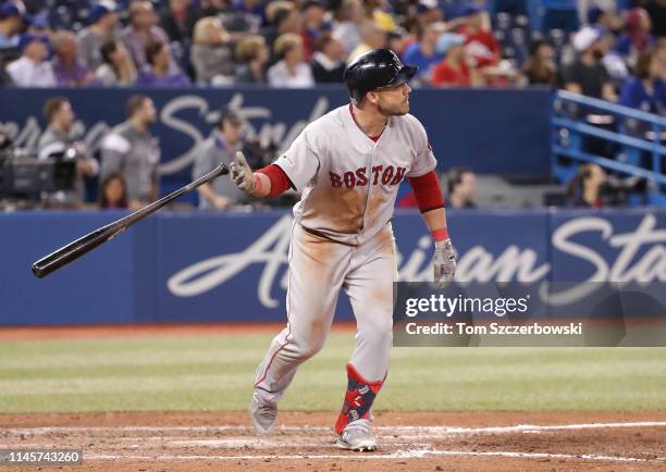 Steve Pearce of the Boston Red Sox tosses aside his bat as he hits a two-run home run in the ninth inning during MLB game action against the Toronto...