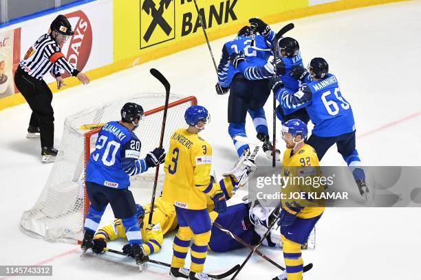 Finland's players celebrate after scoring the 4-4 during the IIHF Men's Ice Hockey World Championships quarter-final match between Finland and Sweden...