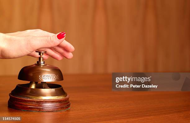 hand on hotel reception bell - bell stock pictures, royalty-free photos & images